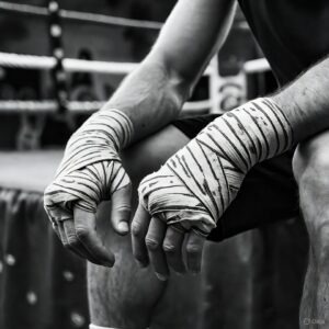 A man's wrapped hands resting after boxing training, representing the HS warrior mindset and a personal warrior plan.