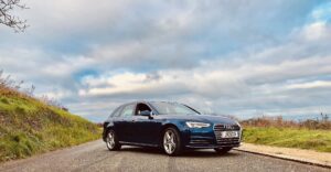 Kerrie's joy: her blue Audi A4 parked on a country road.